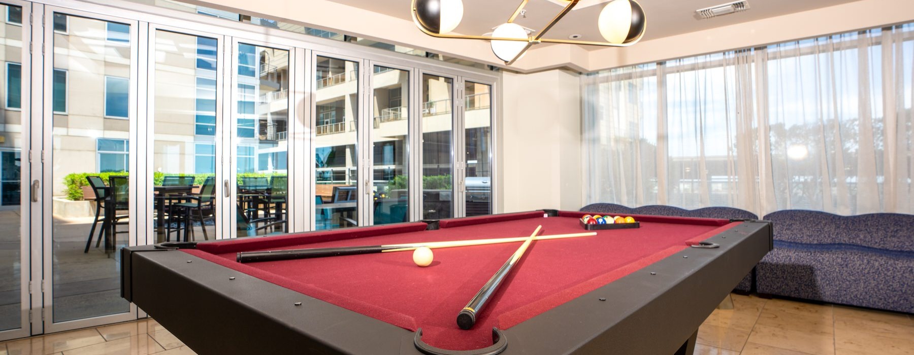 a clubroom with a pool table and a couch